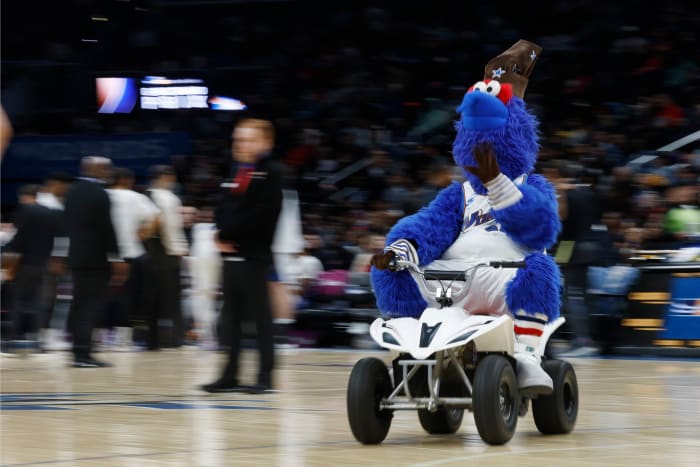 Washington Wizards mascot G-Wiz drives a motorized scooter around the court during a timeout against the Miami Heat in the third quarter at Capital One Arena